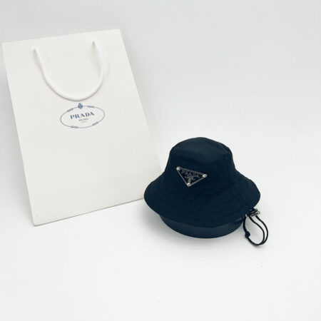 Black Pawda triangle logo bucket hat with adjustable chin strap and Prada shopping bag