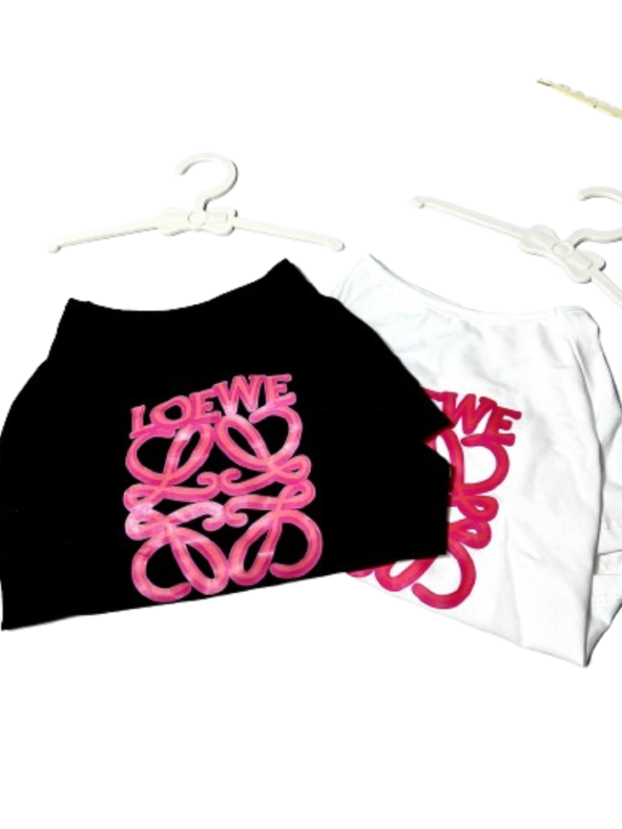 Pink logo script tee for dogs in black and white colorways on hangers