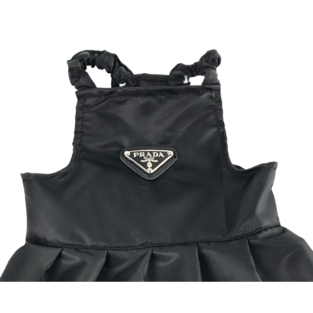 Close-up of black nylon dog dress showing Prada triangle logo detail and construction
