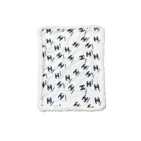 White and black Chanel inspired dog bed with interlocking logo pattern and plush sherpa border trim