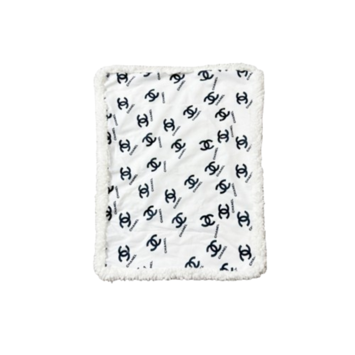 White and black Chanel inspired dog bed with interlocking logo pattern and plush sherpa border trim