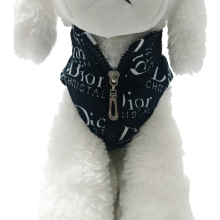Small white dog wearing black Dogior vest with oblique print pattern
