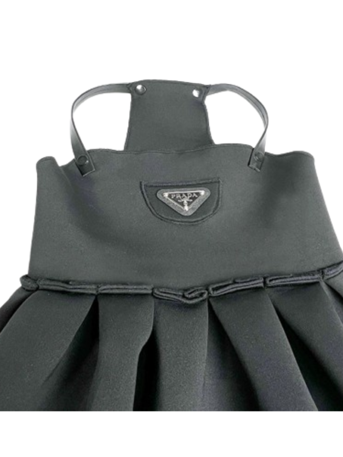 Close-up Pawda triangle logo on gray structured dog dress bodice
