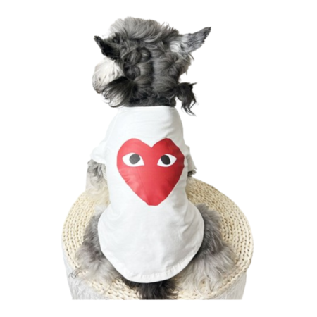 White dog tee with red CDG heart logo on small fluffy dog