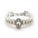 White faux pearl dog necklace with oval rhinestone centerpiece on white background