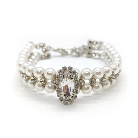White faux pearl dog necklace with oval rhinestone centerpiece on white background
