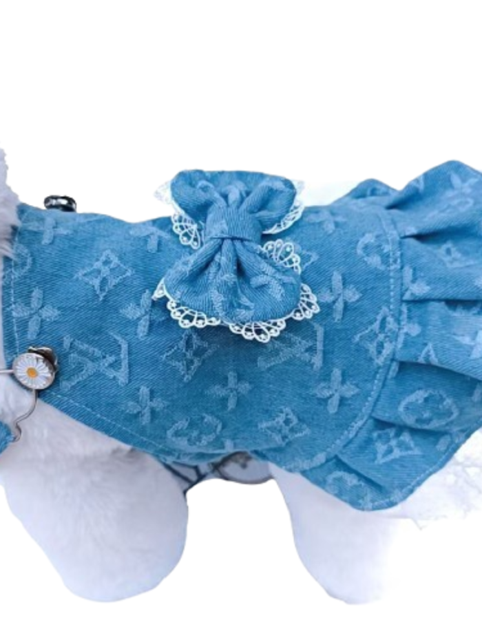 Blue monogram dog dress with bow detail and lace ruffle hem on white dog