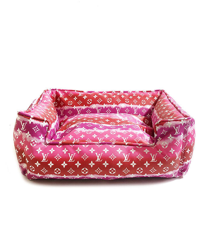 Pink gradient monogram dog bed showing structured bolster sides and plush interior