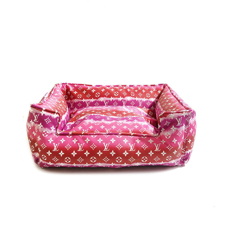 Pink gradient monogram dog bed showing structured bolster sides and plush interior