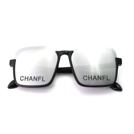 Black plastic dog sunglasses with Chanel branding on dark lenses