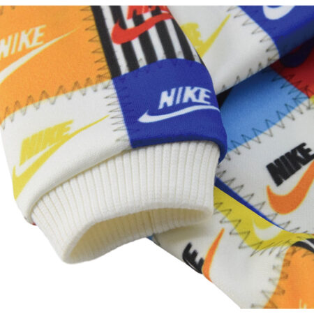Close up of patchwork sweatshirt showing Nike logo squares with white ribbed cuffs