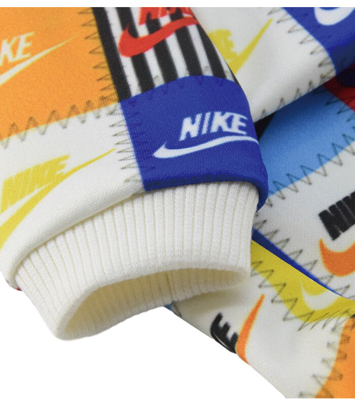 Close up of patchwork sweatshirt showing Nike logo squares with white ribbed cuffs