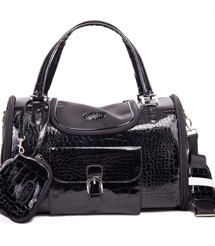 Black crocodile embossed dog carrier with structured silhouette and gold hardware
