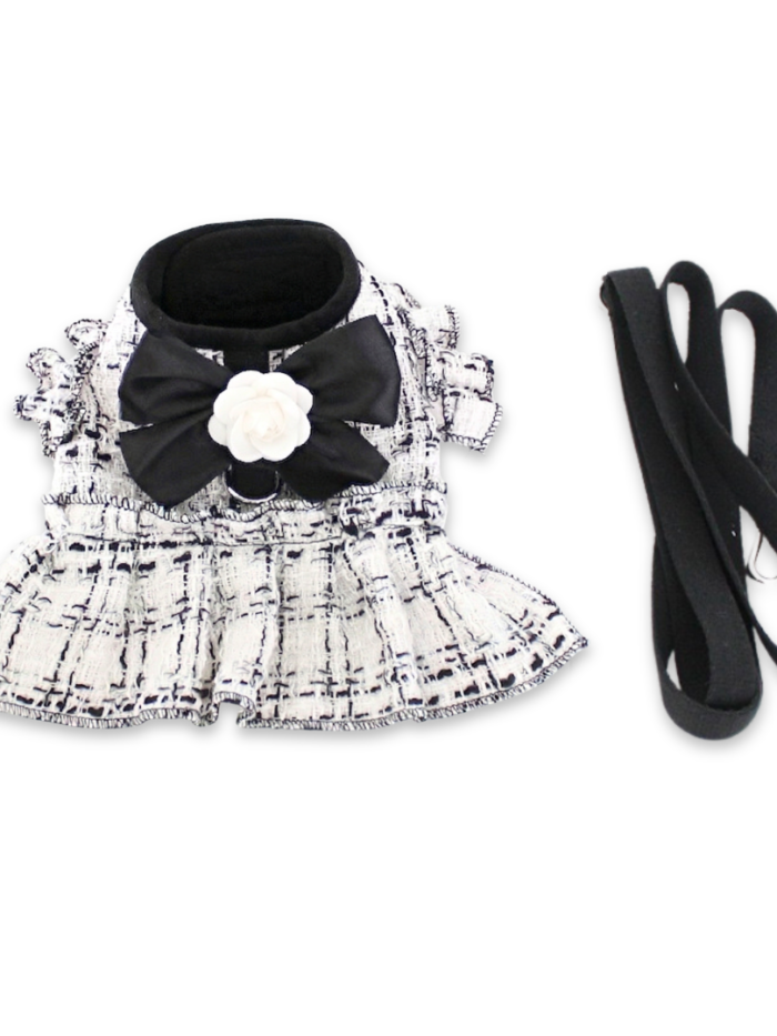 White tweed dog harness dress with black bow and flower detail Chanel style