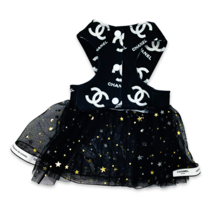 Back view of black star-embellished tulle dog dress with Chanel logo detail and ribbon trim