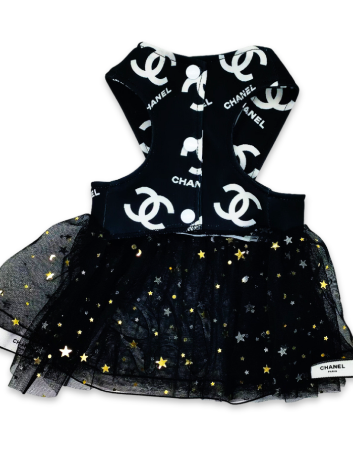 Back view of black star-embellished tulle dog dress with Chanel logo detail and ribbon trim