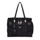 Black nylon dog travel carrier with Prada triangle logo and mesh ventilation panels