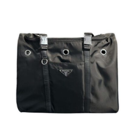 Front view of black Prada-inspired pet carrier showing mesh window and triangle badge detail