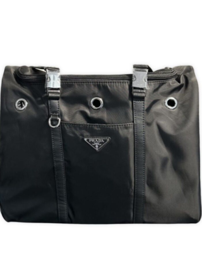 Front view of black Prada-inspired pet carrier showing mesh window and triangle badge detail