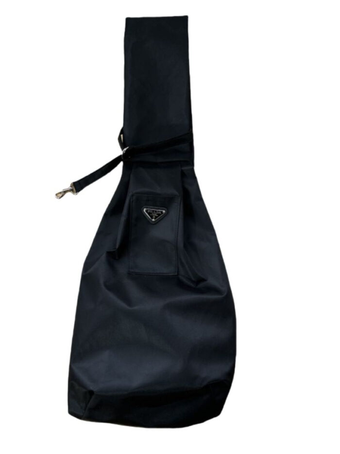 Black nylon dog sling carrier Prada style with triangle logo badge and adjustable strap