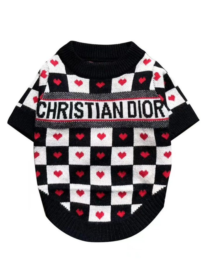 Black and white checkered dog sweater with red hearts and Dogior branding on white background