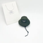 Green Pawda triangle logo bucket hat with chin strap and Prada shopping bag
