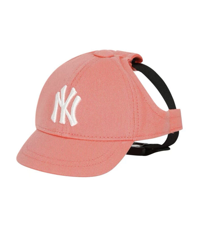Pink dog baseball cap with white embroidered NY Yankees logo and black chin strap