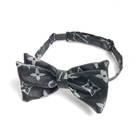 Black monogram bow tie with V pattern and adjustable collar strap closeup