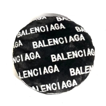 Black faux fur dog bed with white Balenciaga logo print all over surface