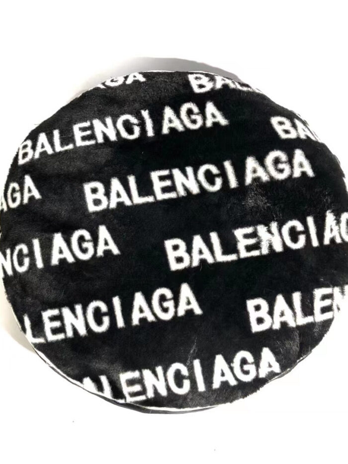 Black faux fur dog bed with white Balenciaga logo print all over surface