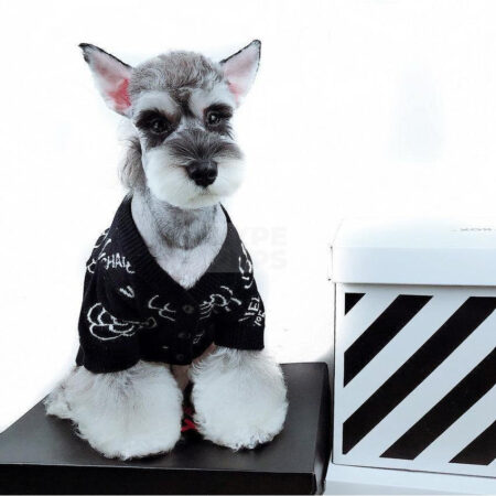 Black knit dog sweater with white Chanel logo and camellia flower print inspired by Chanel