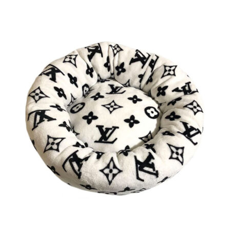 White round dog bed with black Louis Vuitton inspired V monogram pattern and plush construction