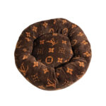 Brown round dog bed with tan Louis Vuitton style V monogram pattern donut shape