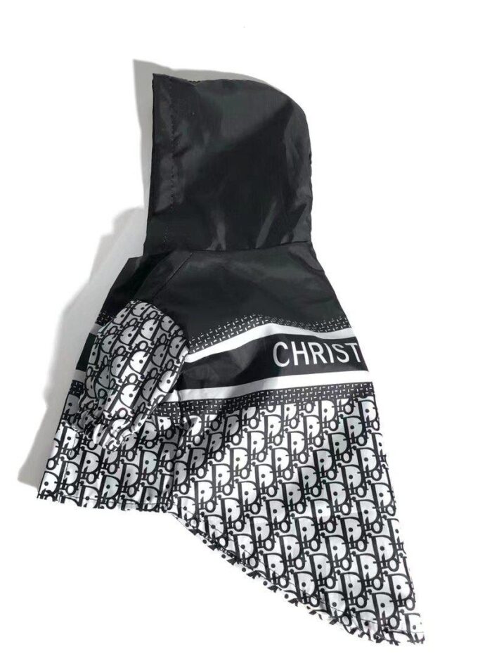 Side view of dog windbreaker showing oblique print pattern and hooded design