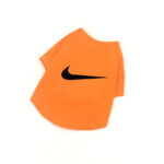 Orange dog tee with black Nike swoosh logo inspired design on chest