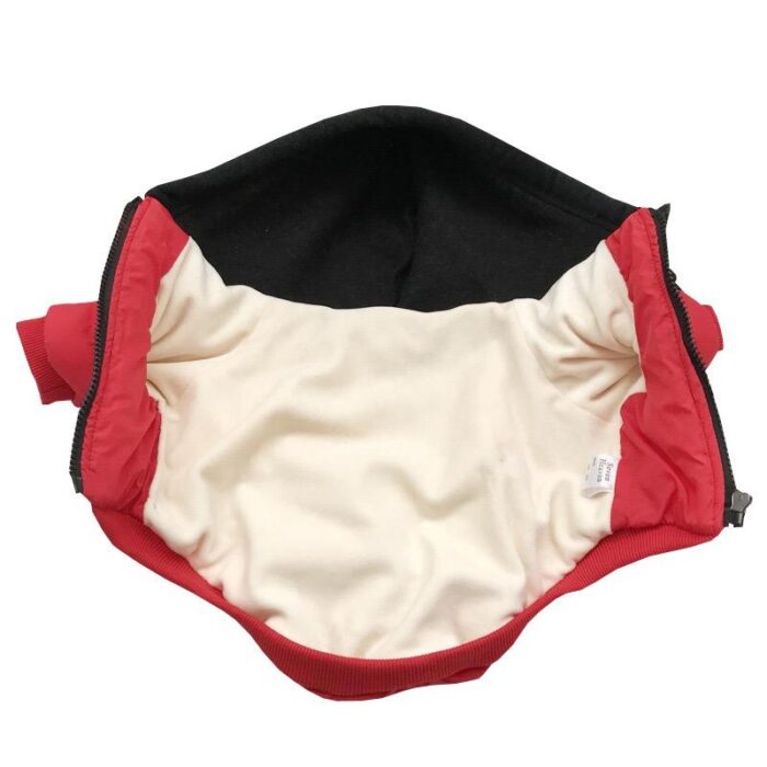 Interior view of red Yankees dog jacket showing cream lining and ribbed trim