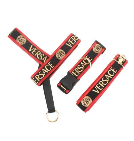Black and red dog harness set with Versace text and gold medusa logos on white background