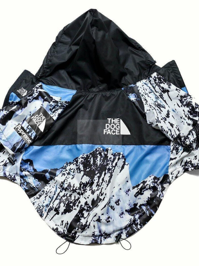 Blue mountain print dog windbreaker with North Face inspired TDF logo flat lay