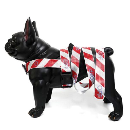 Black dog mannequin wearing red white striped harness with matching leash Off-White style