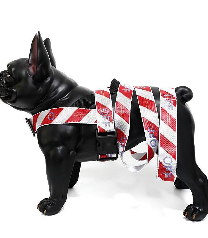 Black dog mannequin wearing red white striped harness with matching leash Off-White style
